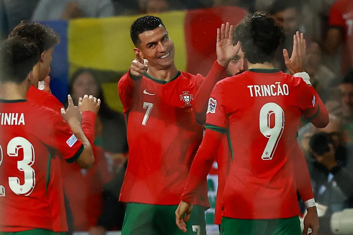 Portugal's Cristiano Ronaldo celebrates with teammates after scoring their fifth goal in a 5-1 rout of Poland.