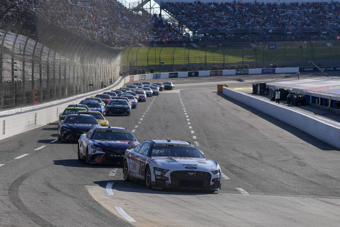 FILE PHOTO: Oct 29, 2023; Martinsville, Virginia, USA; NASCAR Cup Series driver Ryan Blaney (12) leads the pack during the NASCAR Xfinity 500 at Martinsville Speedway. Mandatory Credit: David Yeazell-USA TODAY Sports/File Photo