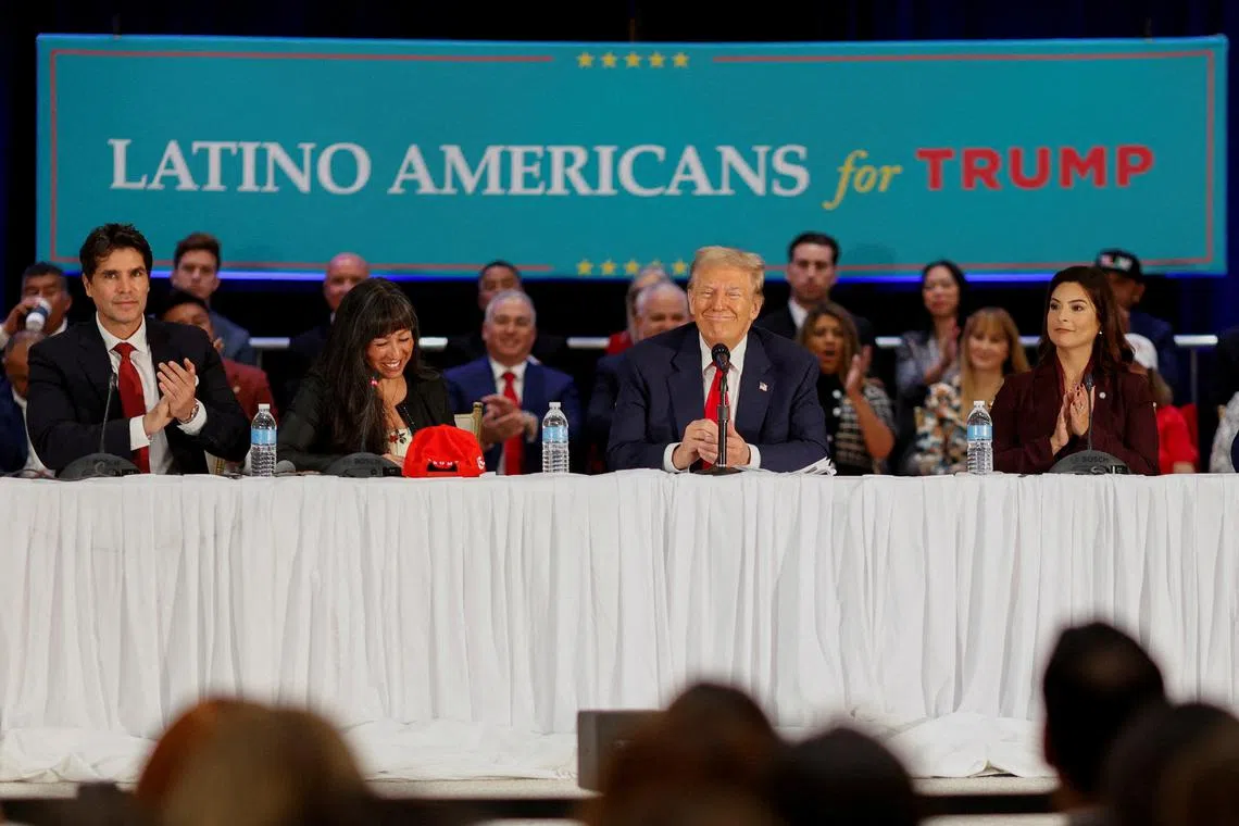 FILE PHOTO: Then-Republican presidential candidate and former U.S. President Donald Trump reacts during a roundtable discussion with Latino community leaders in Doral, Florida, U.S. October 22, 2024. REUTERS/Marco Bello/File Photo