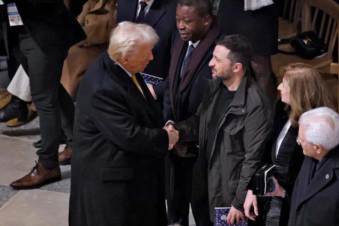 U.S. President-elect Donald Trump and Ukrainian President Volodymyr Zelenskiy shake hands inside the Notre-Dame de Paris Cathedral ahead of a ceremony to mark its re-opening following the 2019 fire, in Paris, France, December 7, 2024. LUDOVIC MARIN/Pool via REUTERS/File Photo