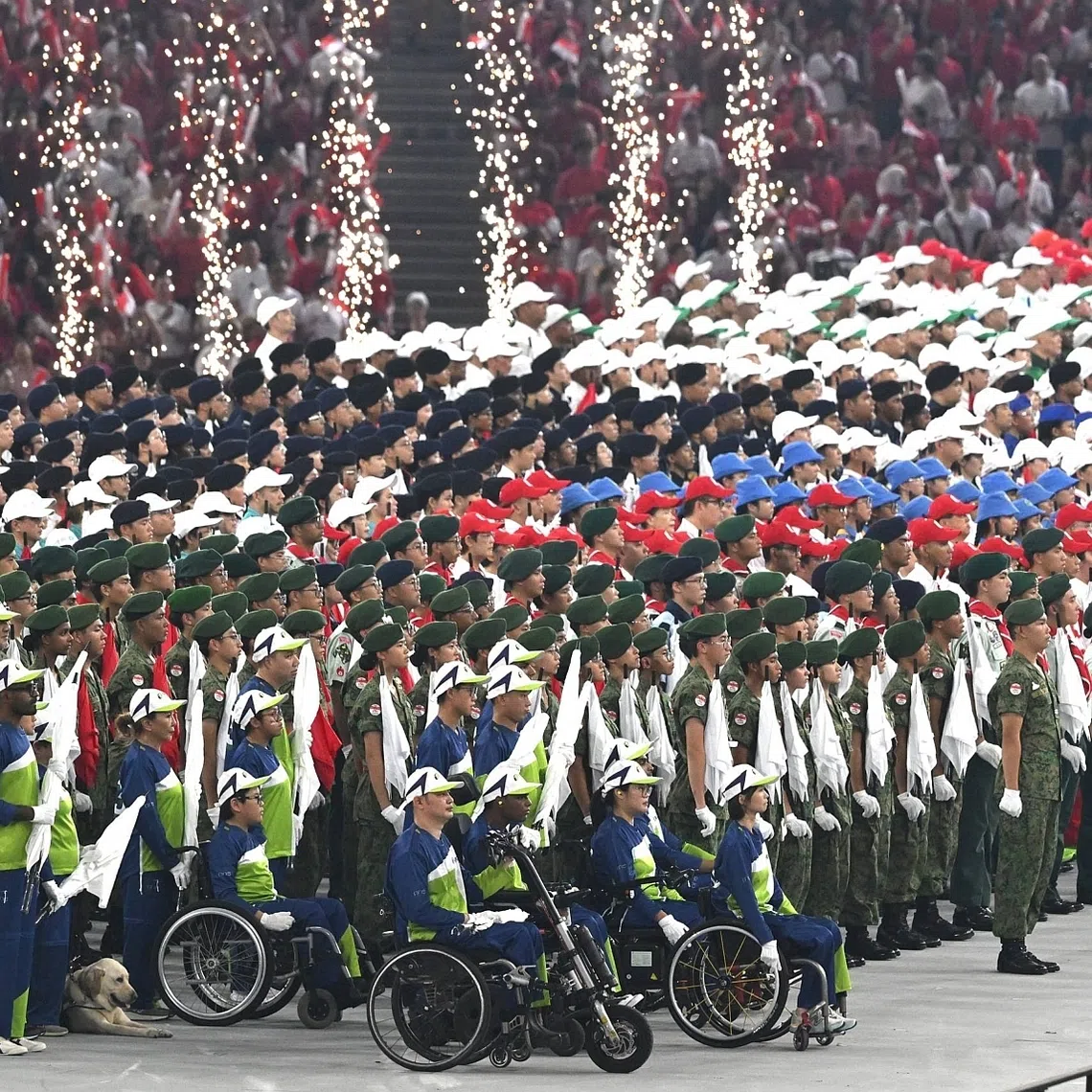 Members of the Singapore Disability Sports Council’s 21-strong contingent on stage with the other parade contingents on Aug 9.