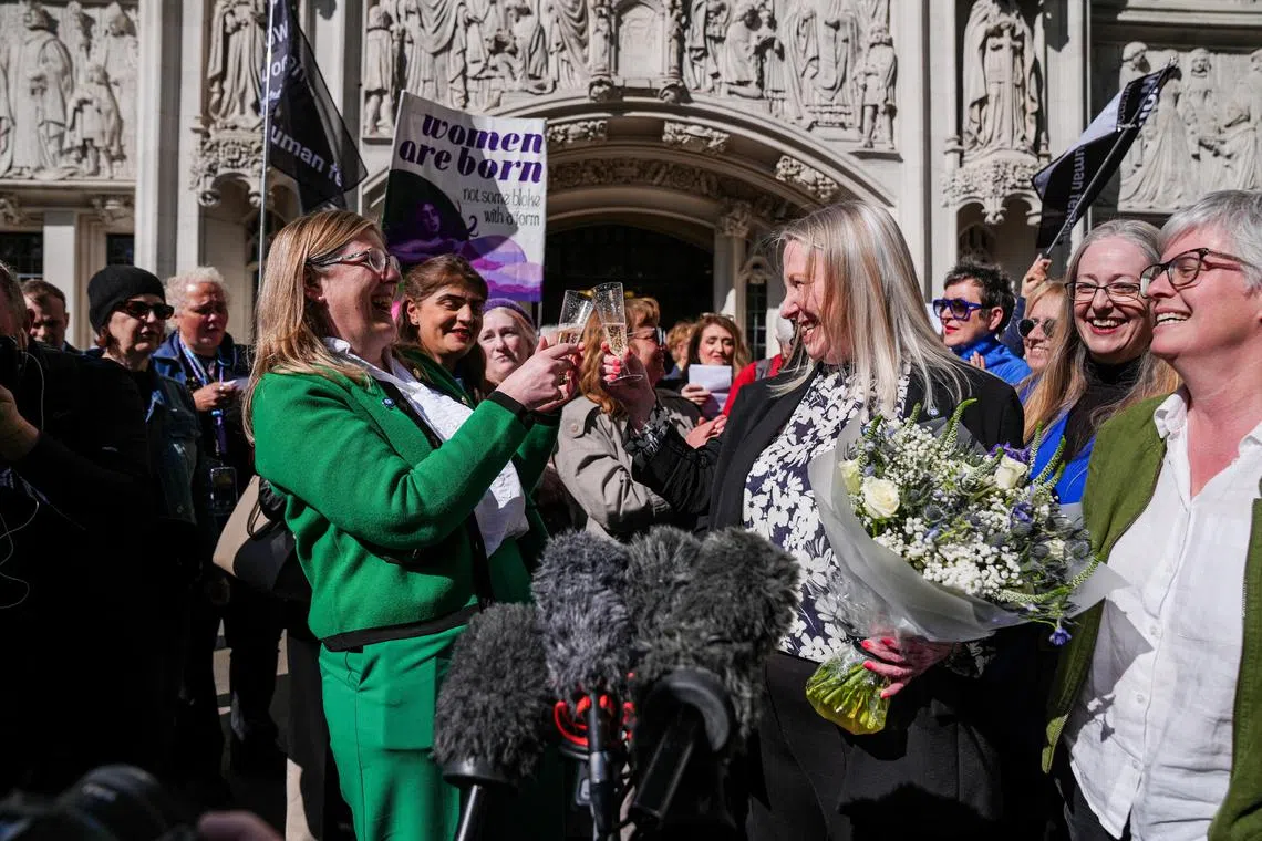 Women celebrating outside the Supreme Court in London on April 16, after Britain's Supreme Court ruled that the definition of a woman under equality legislation referred to “biological sex”.