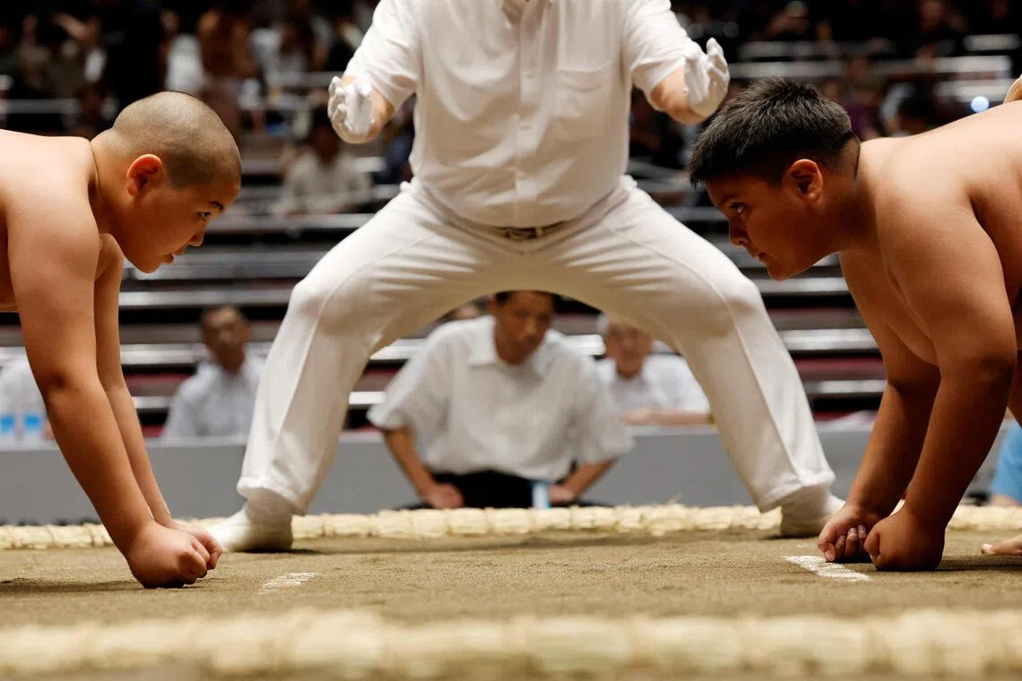 Elementary school sumo wrestlers compete in the sumo ring during the Wanpaku sumo wrestling tournament in Tokyo, Japan, August 2, 2026. REUTERS/Kim Kyung-Hoon     TPX IMAGES OF THE DAY     