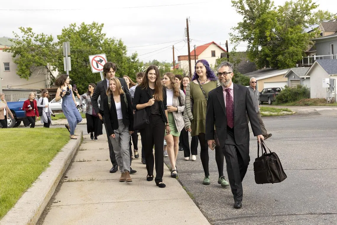 Rikki Held, center, and Olivia Vesovich, second from right, who are among a group of young people suing the state government, walk towards a courthouse in Helena, Mont., June 12, 2023. Sixteen young people argue that the state is robbing their future by embracing policies that contribute to climate change. (Janie Osborne/The New York Times)