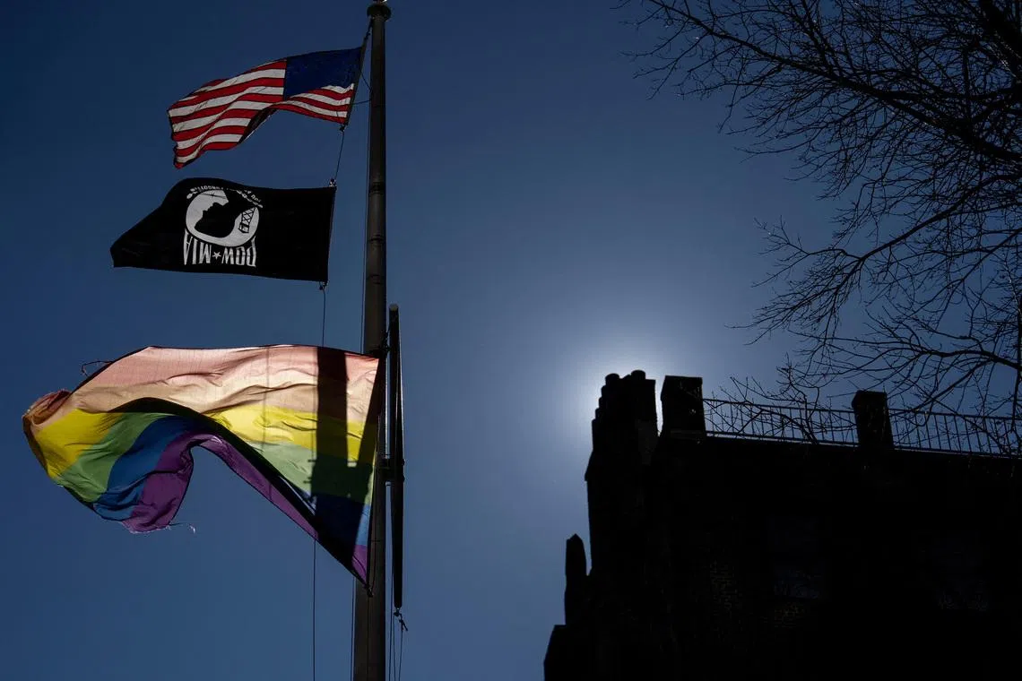 FILE PHOTO: A Pride flag flies over the Stonewall National Monument as people protest against U.S. President Donald Trump's administration's move to restrict transgender rights, in New York City, U.S., February 14, 2025. REUTERS/David 'Dee' Delgado/File Photo