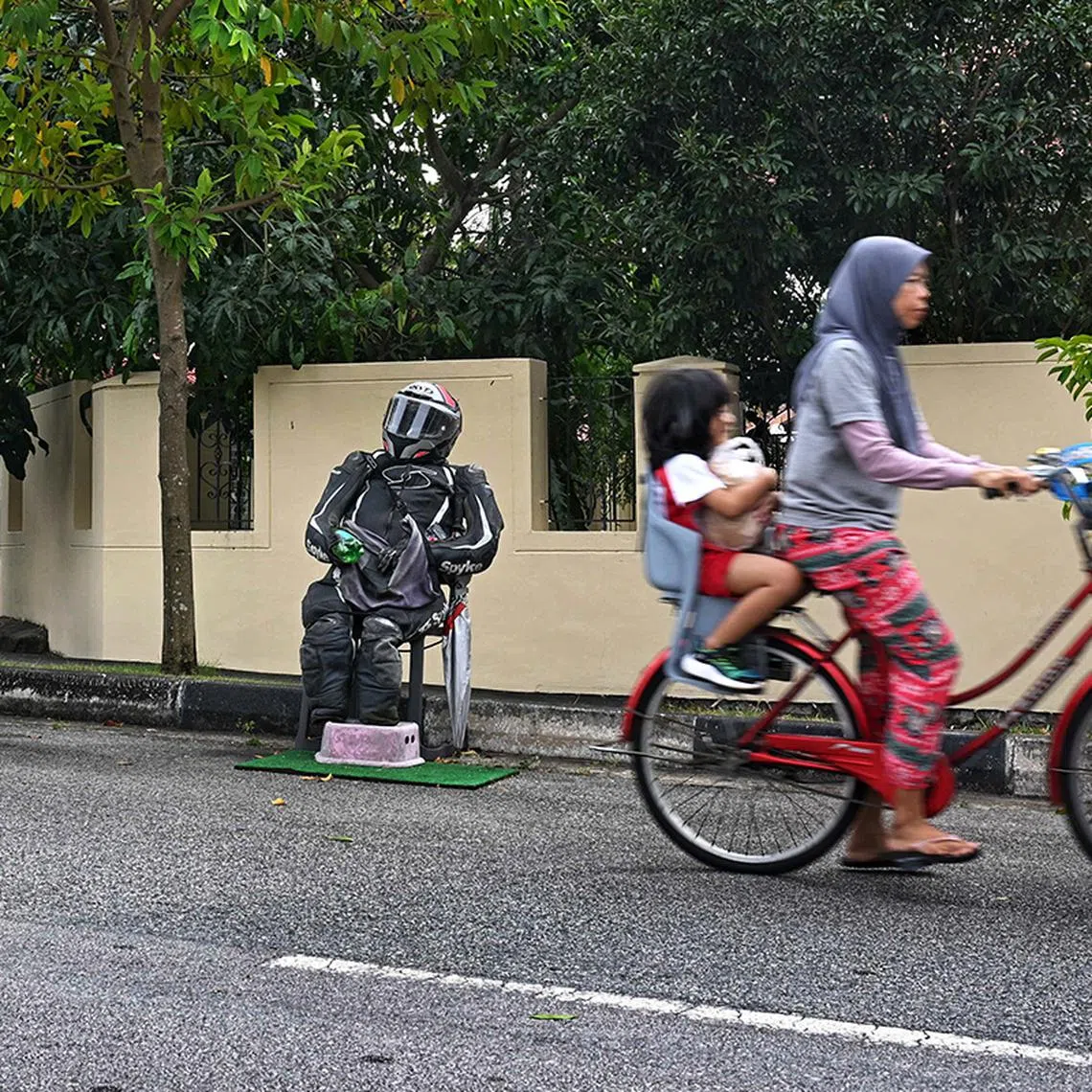 A rudimentary mannequin dressed in a biker suit and helmet serves as informal rally / ? chope ? point for motorcyclists to park their bikes at Punggol Seventeen Avenue seen on Jan 9, 2024.