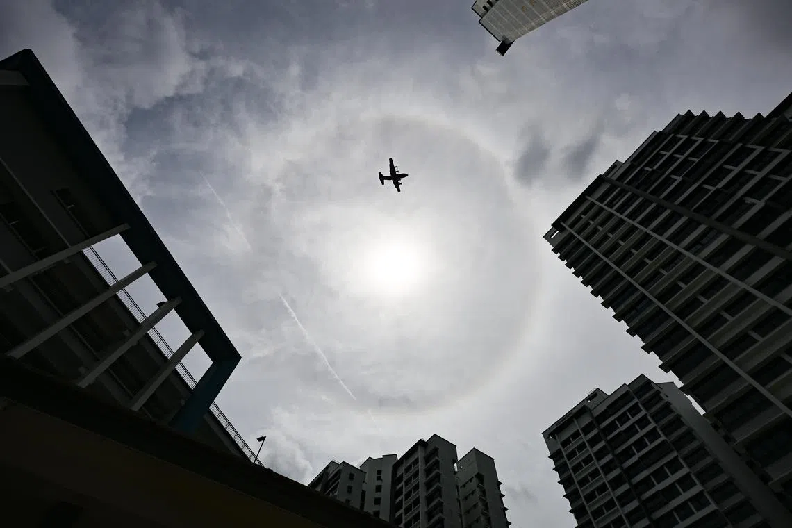 A plane flying past a sun halo seen at Tah Ching Road, on Feb 19, 2025. 