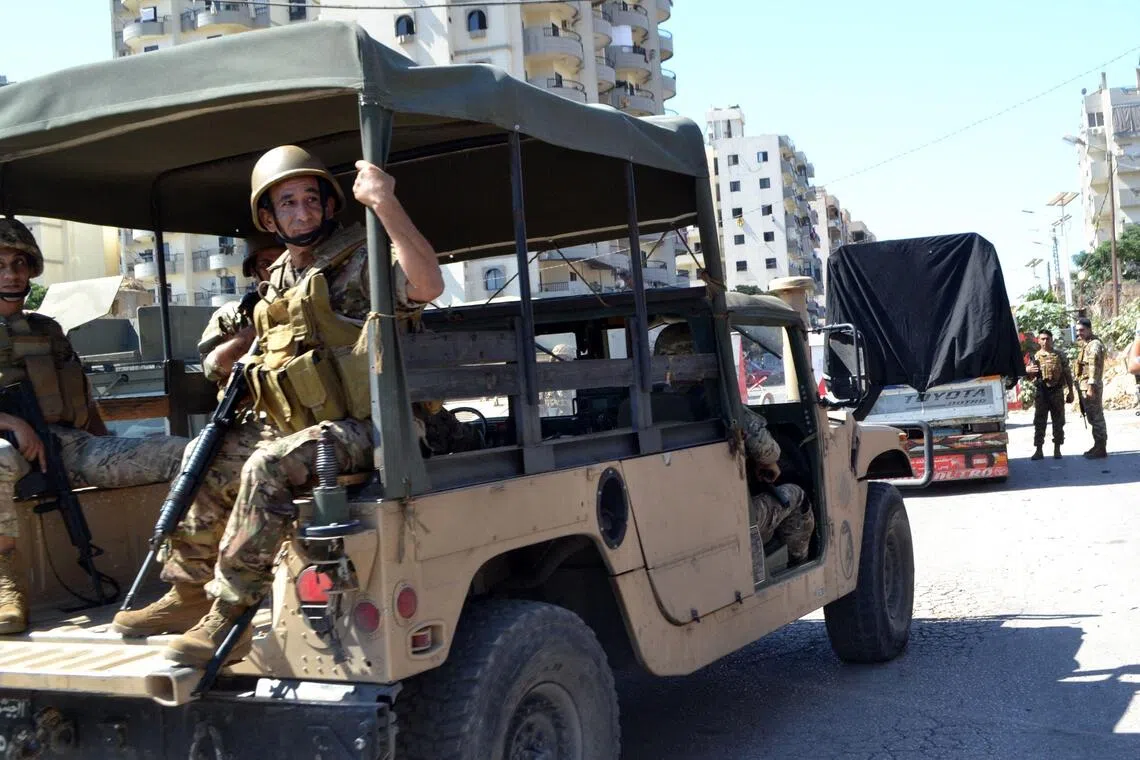 Lebanese army soldiers accompany a truck loaded with weapons, as it leaves the Palestinian refugee camp of Beddawi, near the northern city of Tripoli on Sept 13, 2025. 