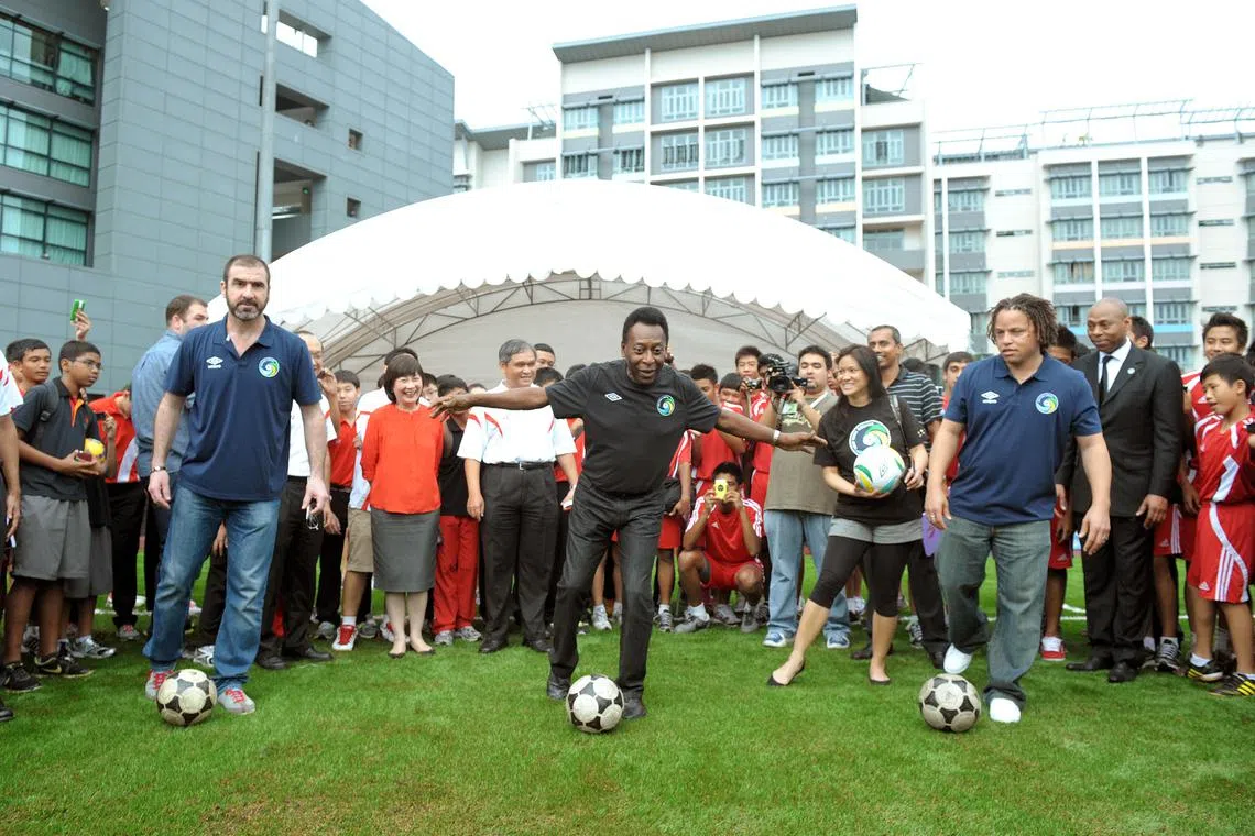 Retired international football legends (from left) Eric Cantona, Pele and Cobi Jones during the launch of the re-turfed football pitch at the Singapore Sports School on 4 March 2011. They are on a promotional tour for the New York Cosmos.