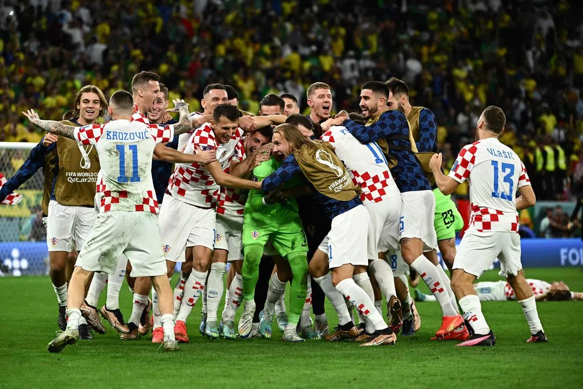 Croatia players celebrating after beating Brazil in the penalty shoot-out of their World Cup quarter-final clash.
