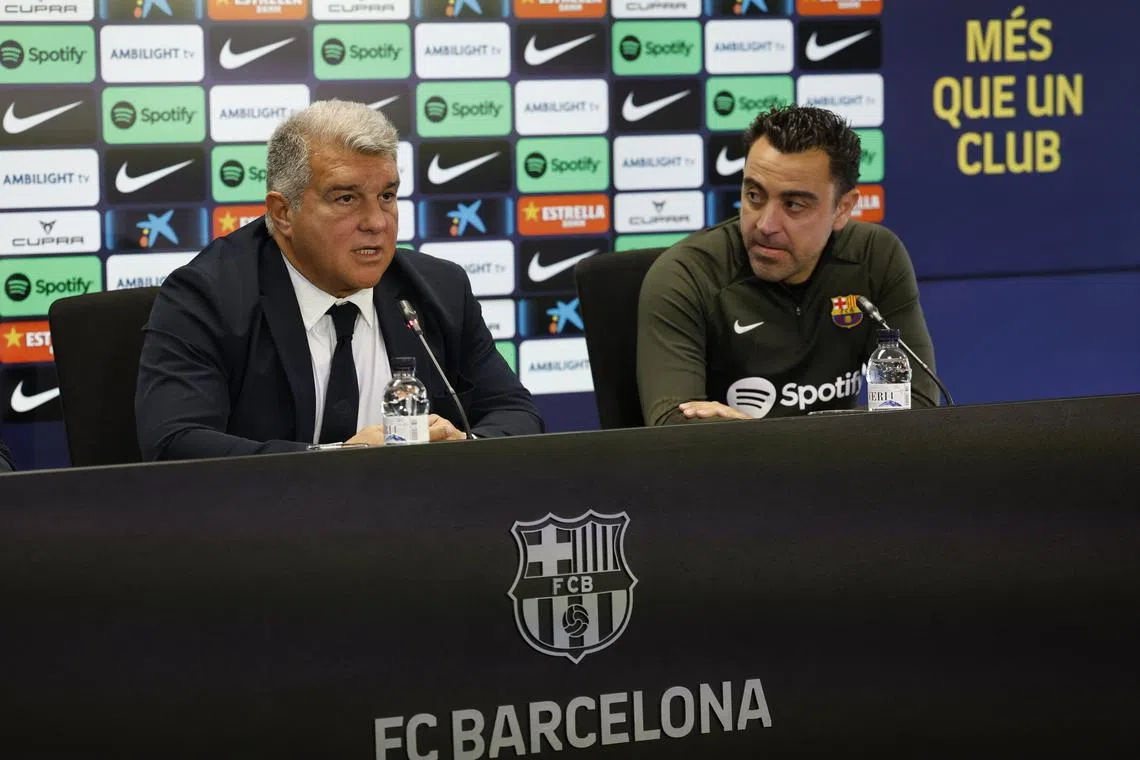 FILE PHOTO: Soccer Football - FC Barcelona Press Conference - Ciutat Esportiva Joan Gamper, Barcelona, Spain - April 25, 2024 FC Barcelona coach Xavi and president Joan Laporta during the press conference REUTERS/Albert Gea/File Photo