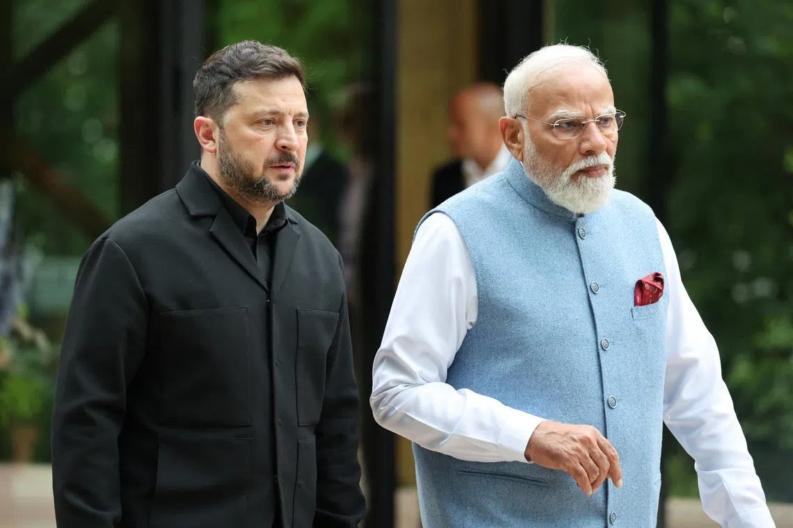 Ukraine's President Volodymyr Zelenskyi and India's Prime Minister Narendra Modi talk before  a family photo photograph prior to a gala dinner as part of the G7 summit in Evian-les-Bains, France, June 16, 2026. Ludovic Marin/Pool via REUTERS