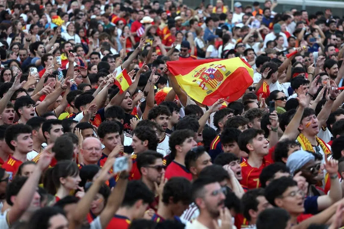 Spain supporters cheer on their team in Madrid.