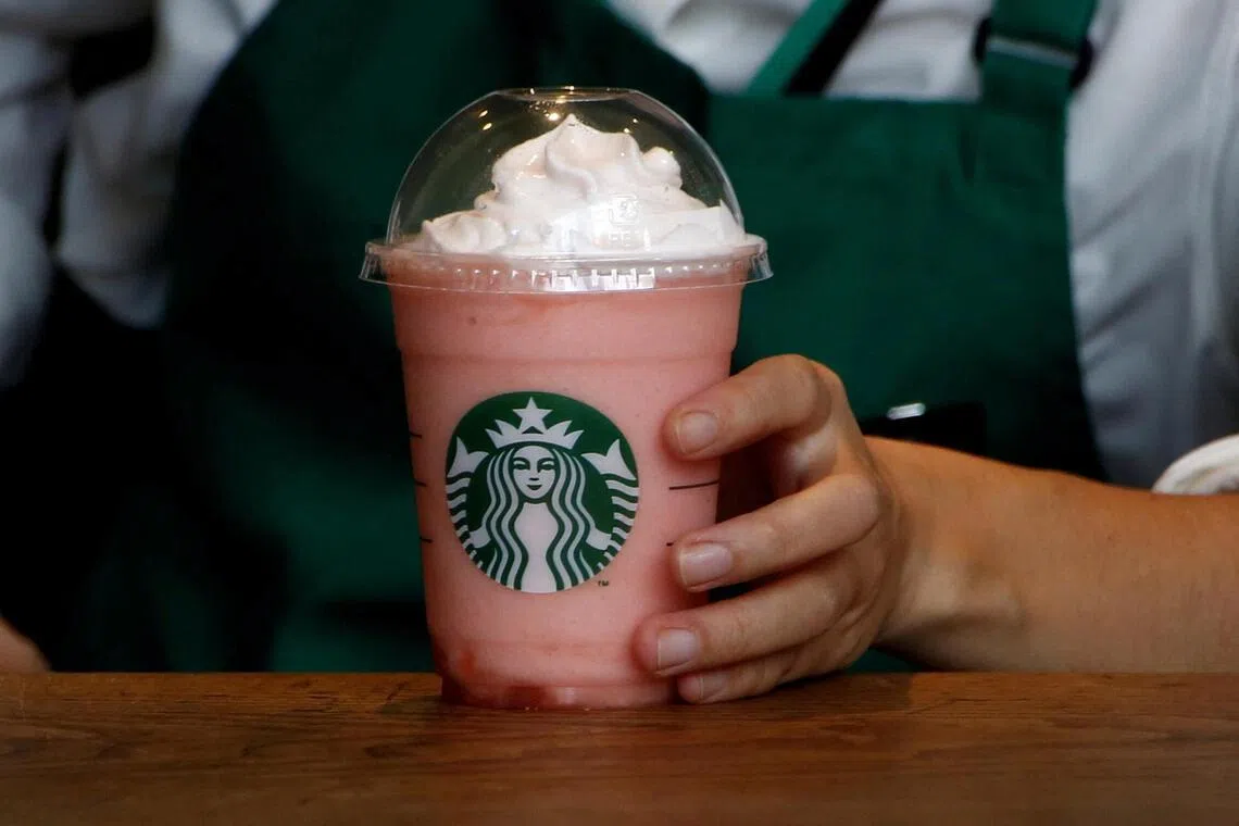 A waitress prepares a beverage at a branch of Starbucks coffee in Tokyo, Japan.
