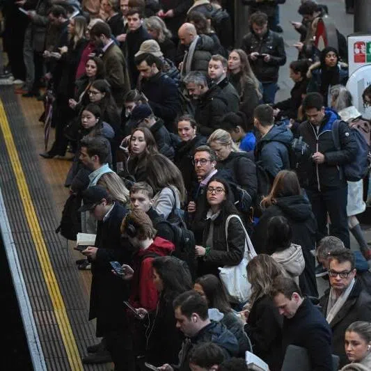 Commuters wait for a train on the platform at Earls Court Tube station in London. In the past three years, the employment rate of working-age people in the OECD is at an all-time high.