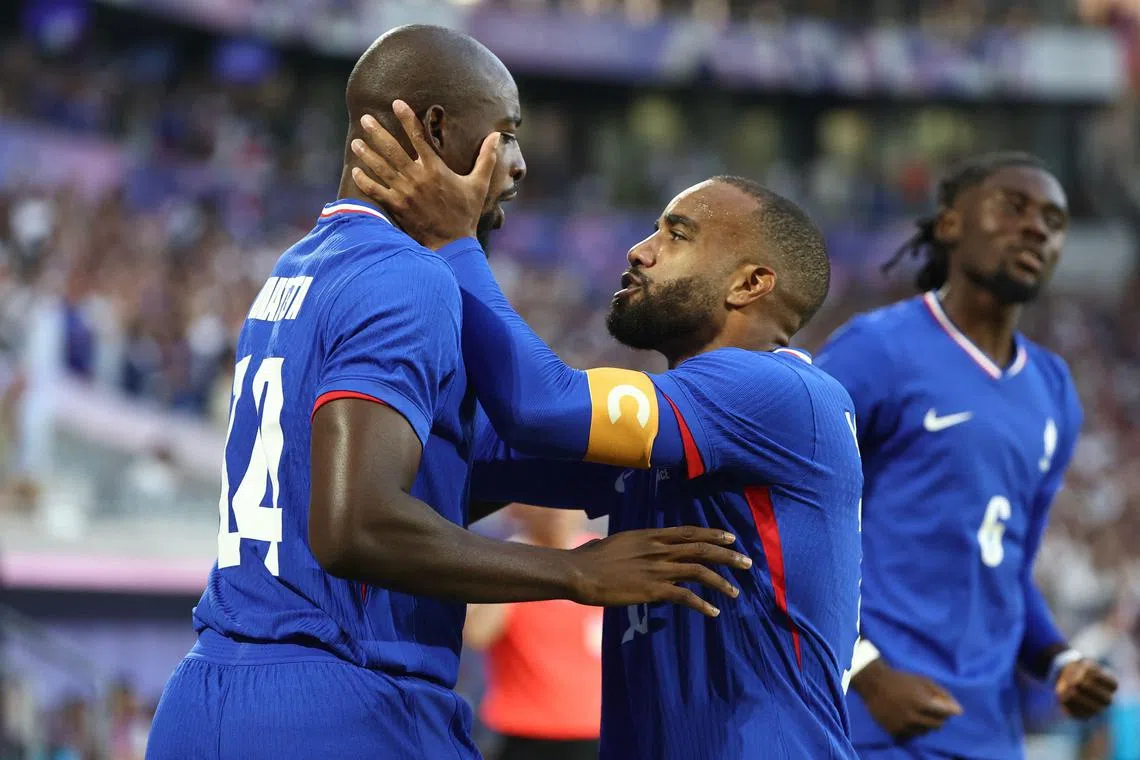 Jean-Philippe Mateta (left) celebrates with teammate Alexandre Lacazette after scoring for France.