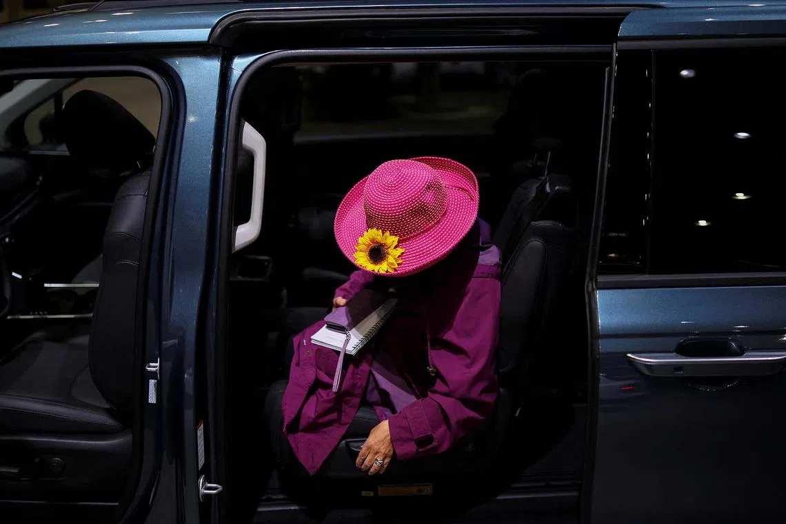 A woman sitting inside a 2025 Kia Carnival during the Los Angeles Auto Show, in Los Angeles, California, US, Nov 21, 2024. 
