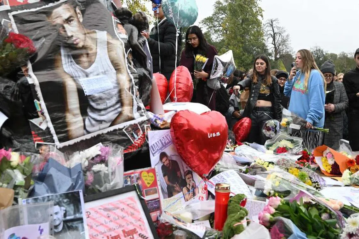 Pictures and notes to former One Direction singer Liam Payne, who died on Oct 16, displayed beside the Peter Pan statue in Kensington Gardens, in London on Oct 20, 2024. 