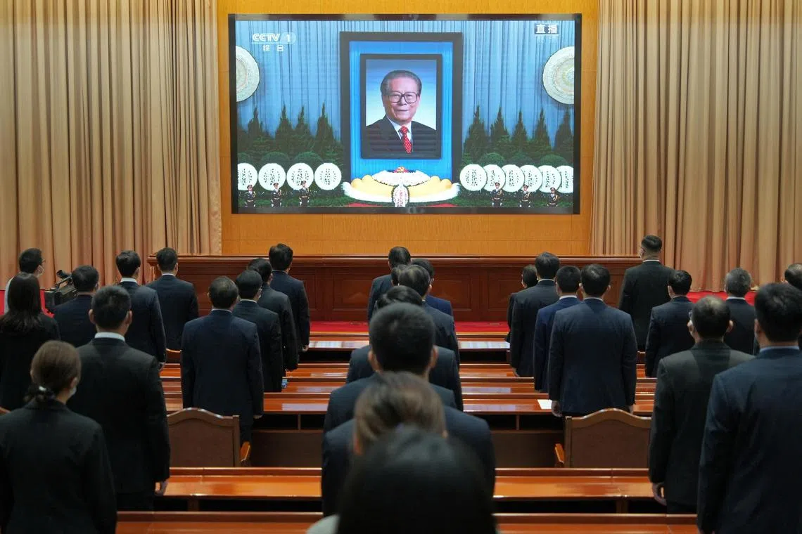 Members of the Communist Party of China watch the live broadcast of the memorial meeting for former Chinese President Jiang Zemin, in Yantai, Shandong province, China December 6, 2022. China Daily via REUTERS  ATTENTION EDITORS - THIS IMAGE WAS PROVIDED BY A THIRD PARTY. CHINA OUT. 