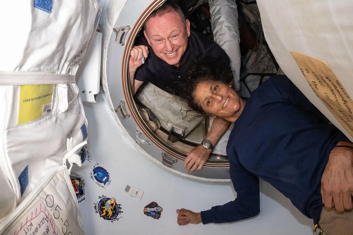 This undated handout picture from Nasa released on July 2 shows Nasa's Boeing Crew Flight Test astronauts (from top) Butch Wilmore and Suni Williams inside the vestibule between the forward port on the International Space Station’s Harmony module and Boeing's Starliner spacecraft. 