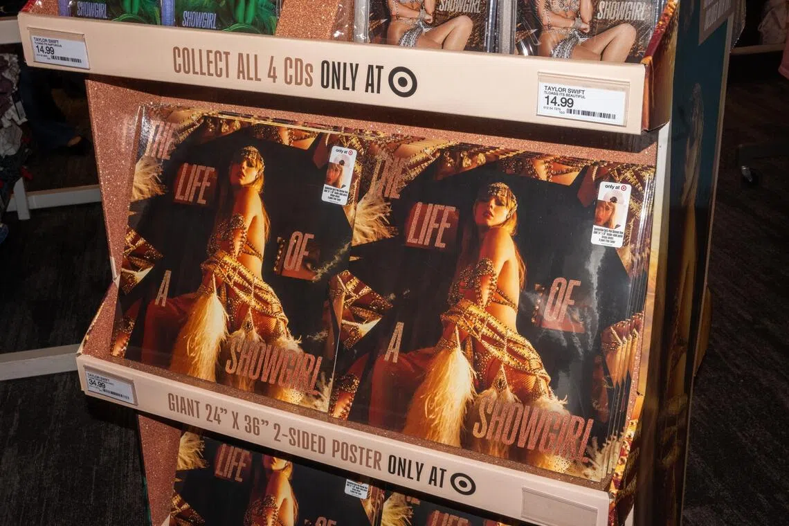 Copies of US singer Taylor Swift's album The Life of a Showgirl - which feature her wearing a Bob Mackie costume on the cover - are seen on a stand during the release party at Target in Times Square, in New York, US on Oct 3 2025. 