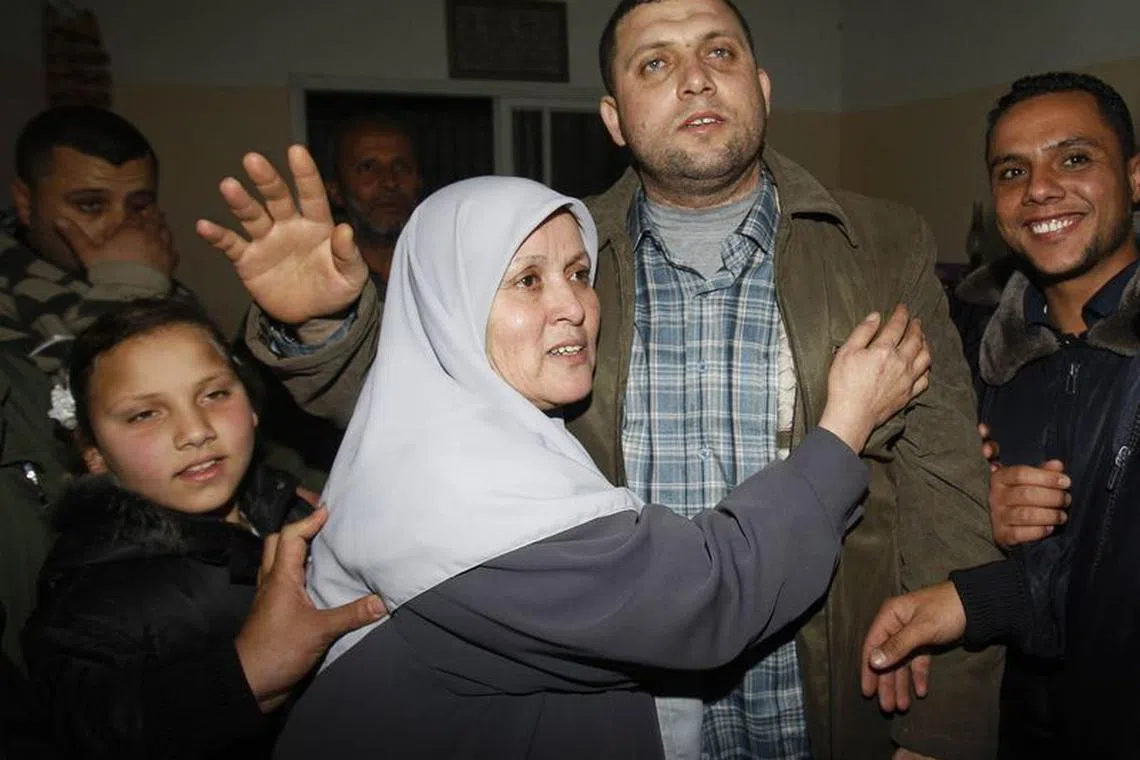 Ayman Nofal (2nd R), a top Hamas armed commander, is greeted by his relatives upon his arrival to his home in Nusairat in the Central Gaza strip February 5, 2011/File Photo