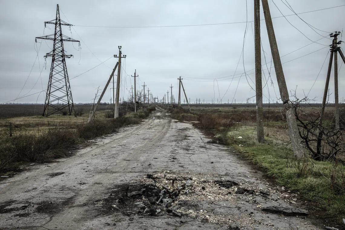 Downed power lines along a road shelled by Russian forces in Posad-Pokrovs'ke, Ukraine, on Dec 3, 2022.