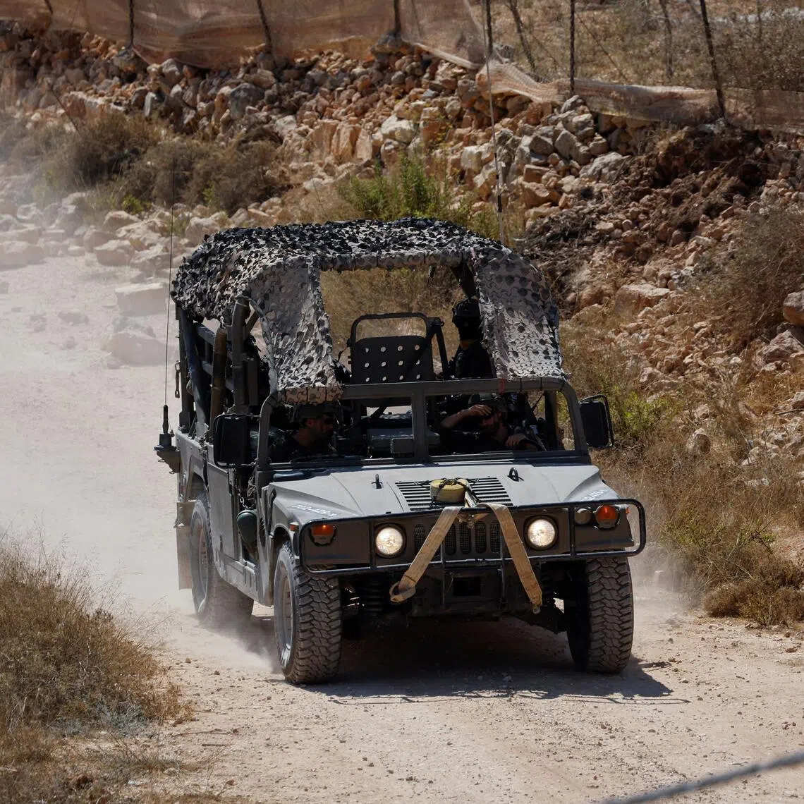 An Israeli military vehicle driving down a road in the Israeli-occupied West Bank on Aug 19.