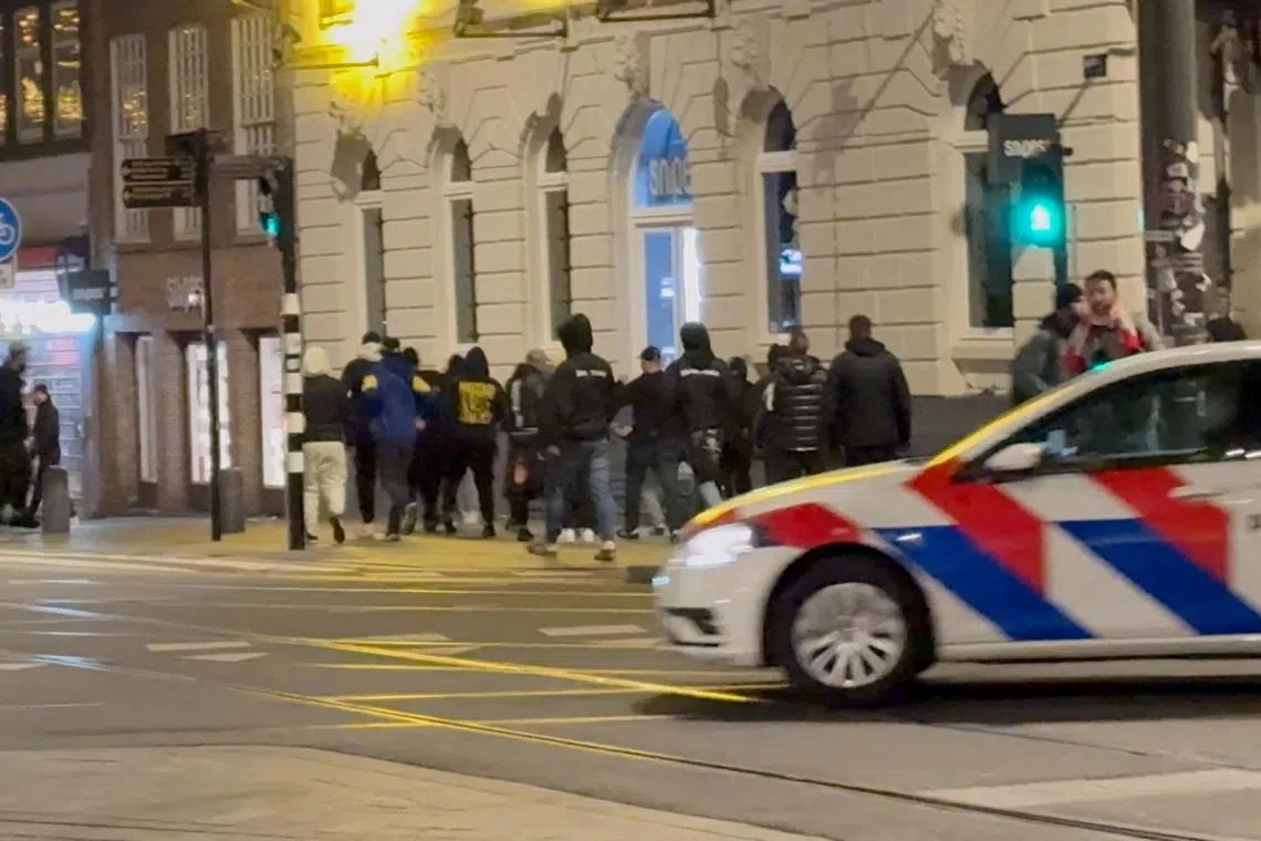Israeli football supporters and Dutch youth clash near Amsterdam Central station, in Amsterdam, Netherlands, November 8, 2024, in this still image obtained from a social media video. X/iAnnet/via REUTERS