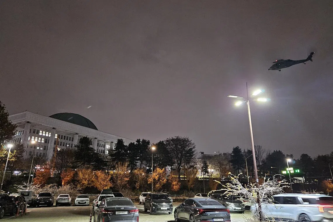 epa11754572 A helicopter hovers over the National Assembly in Seoul shortly after South Korean President Yoon Suk Yeol declared martial law in Seoul, South Korea, 03 December 2024. South Korean President addressed the nation citing the need to root out pro-North Korean forces and uphold the constitutional order. EPA-EFE/YONHAP SOUTH KOREA OUT