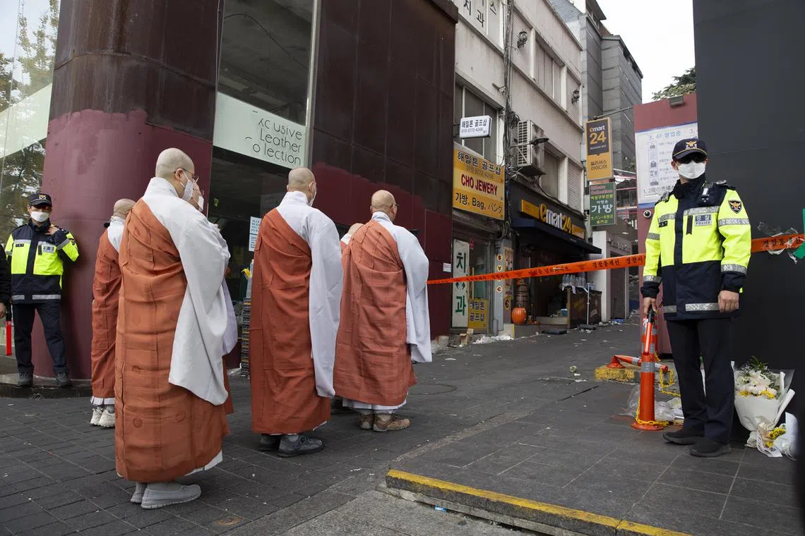 Buddhist monks pay tribute to victims of the Seoul Halloween crowd crush, in Seoul, South Korea, Nov 1, 2022. 