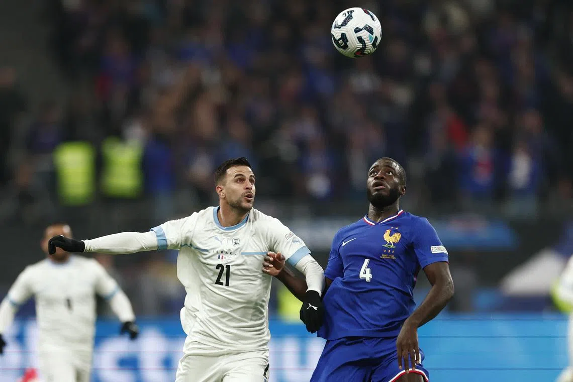 Israel's Dean David (left) in action with France's Dayot Upamecano.