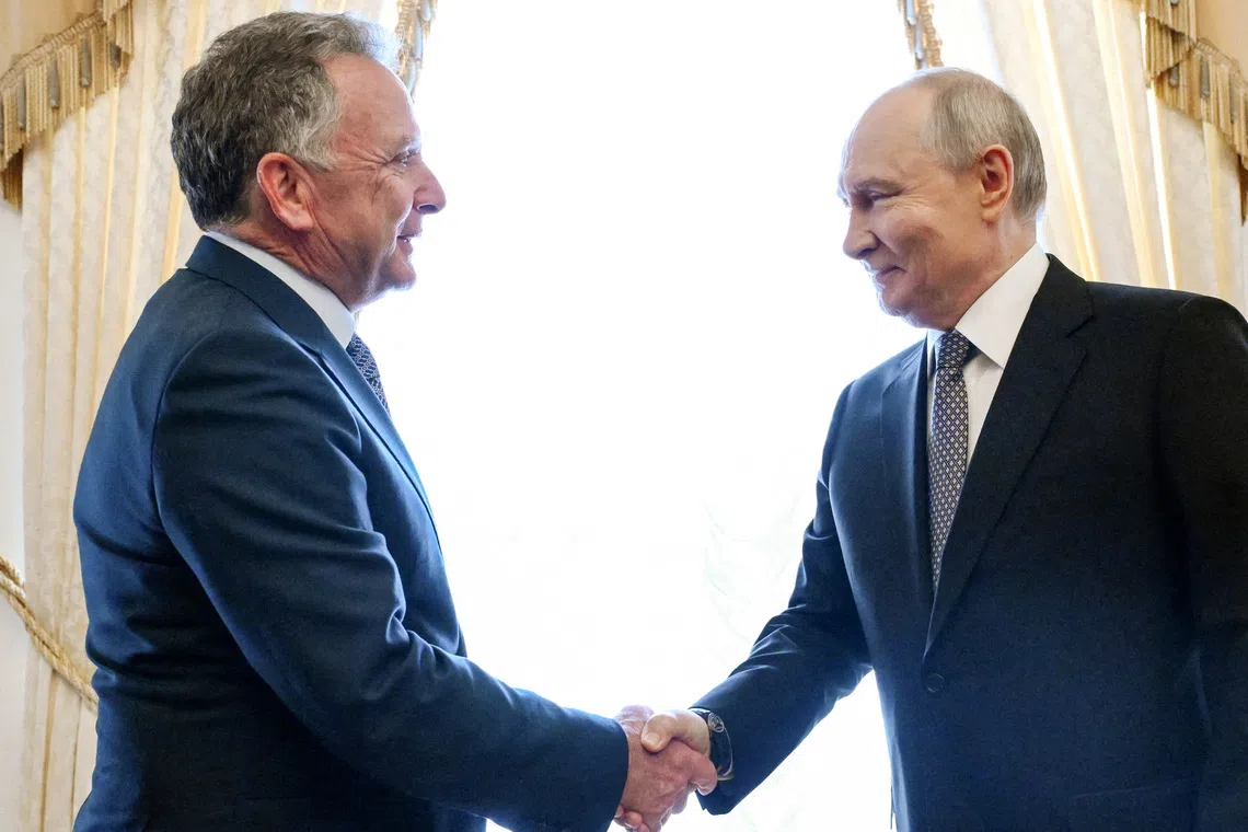 Russian President Vladimir Putin (right) shakes hands with US special envoy Steve Witkoff during a meeting in Saint Petersburg, Russia, on Oct 21.