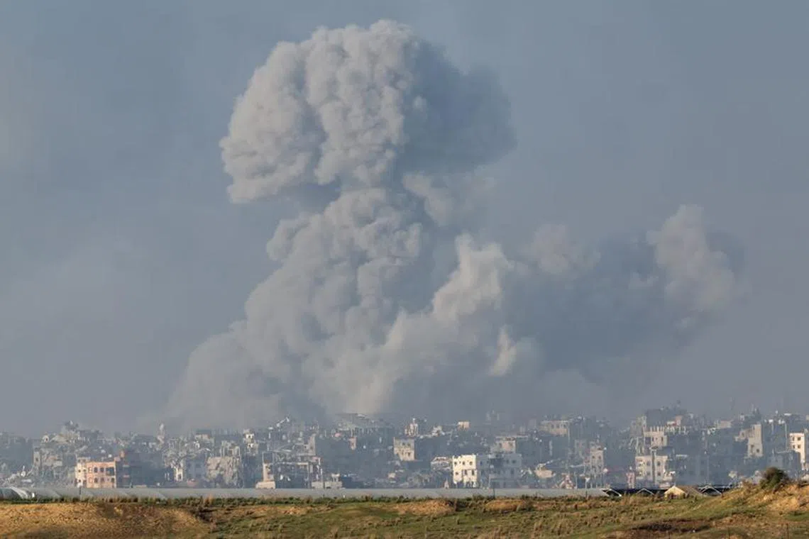 Smoke rises over destroyed buildings in Gaza, amid the ongoing conflict between Israel and the Palestinian Islamist group Hamas, as seen from southern Israel, December 6, 2023. REUTERS/Athit Perawongmetha