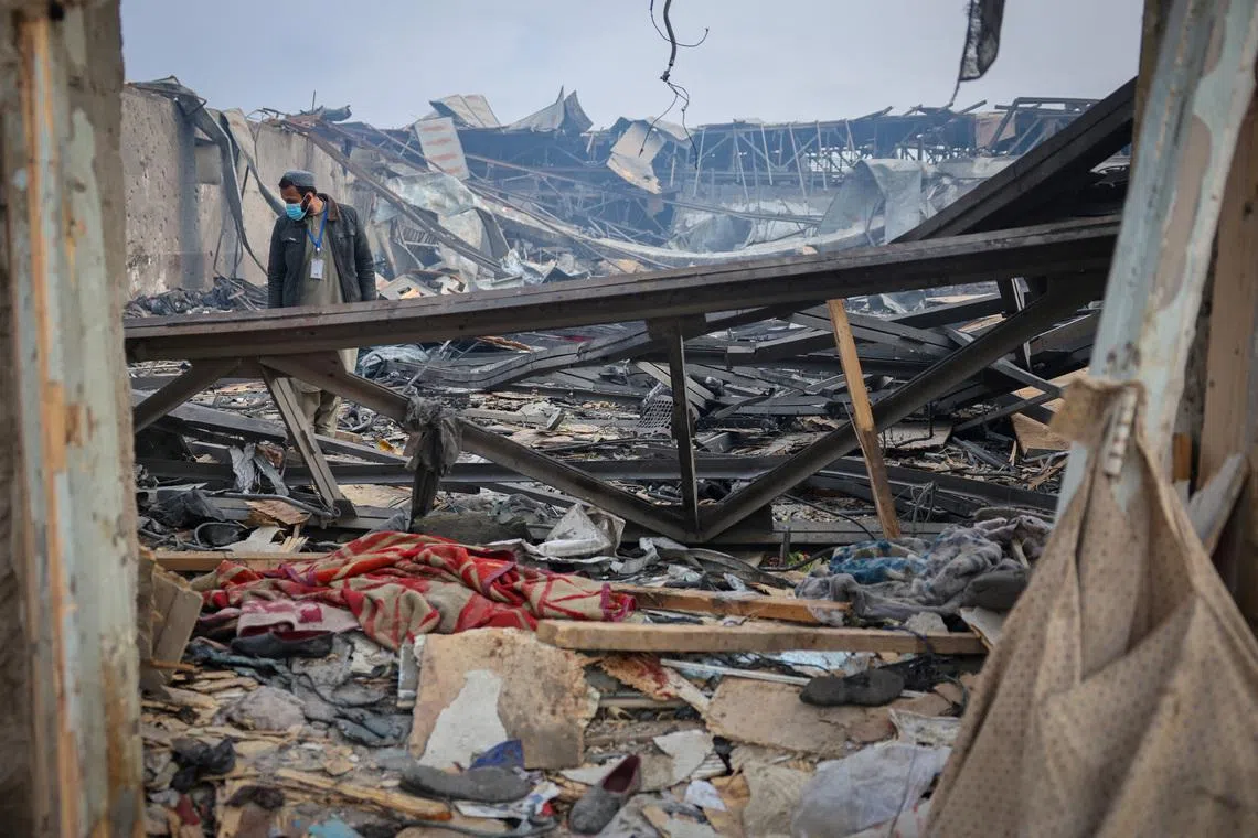 A man walks through debris at the site of a drug users rehabilitation hospital destroyed in what the Taliban said was a Pakistani air strike in Kabul, Afghanistan, March 17, 2026. REUTERS/Sayed Hassib