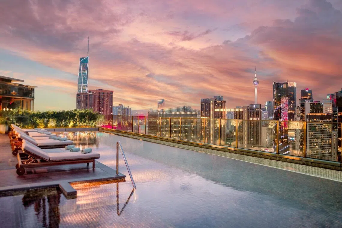 Iconic Malaysian towers Merdeka 118 and KL Tower can be seen from the rooftop pool, 26 storeys up, at Kimpton Naluria Kuala Lumpur.