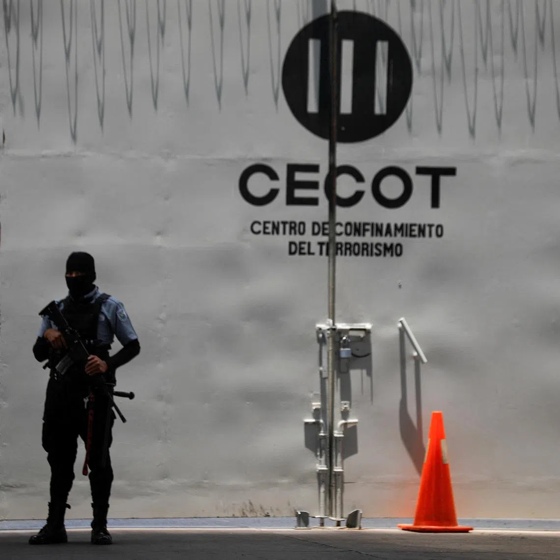 A prison guard stands near a CECOT logo at the Terrorism Confinement Center (CECOT) in Tecoluca, El Salvador, April 23, 2026.REUTERS/Jose Cabezas