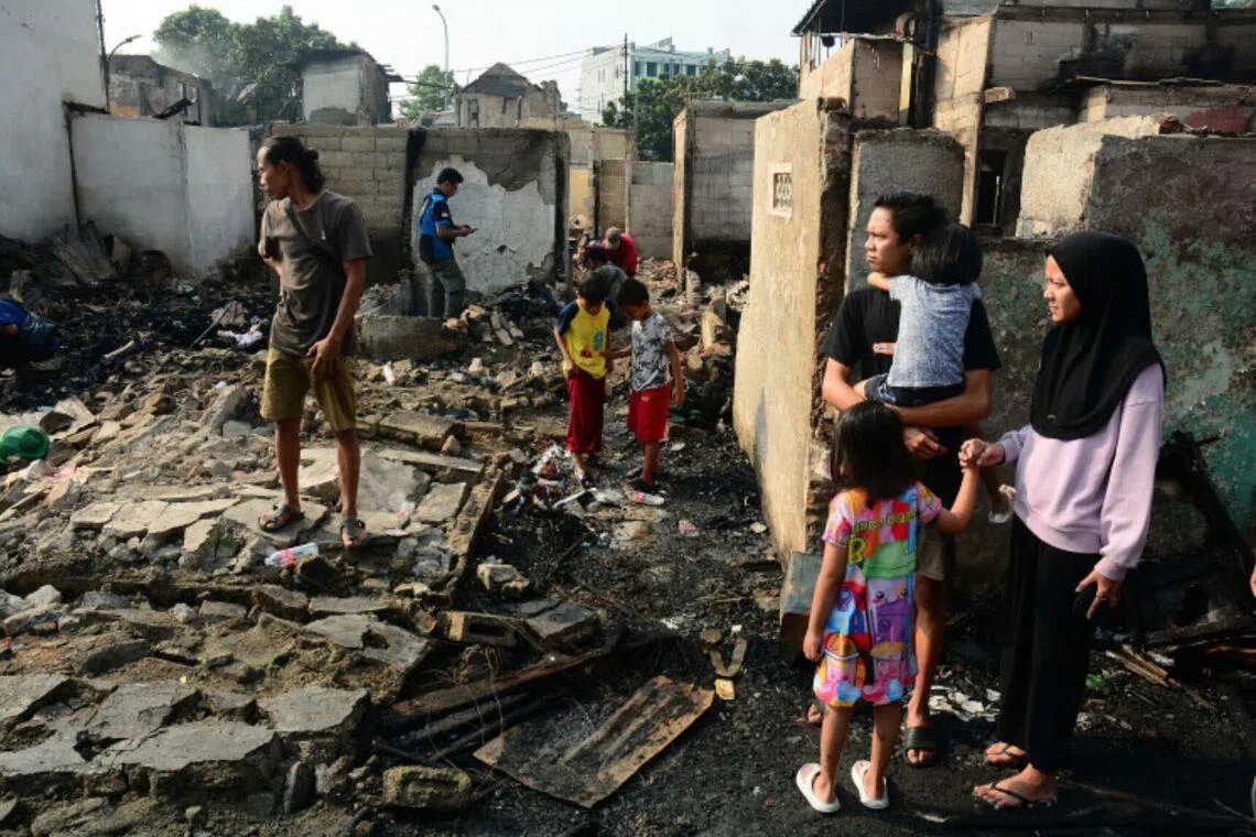 Residents inspect the remains of their homes after a fire broke out in the Kebon Kosong sub-district in Central Jakarta on June 1.