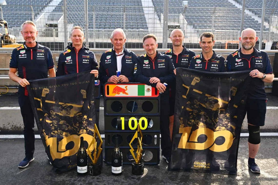 The seven team members of the Red Bull Racing team who have been present for all 100 race wins, including team principal Christian Horner (fourth from left).