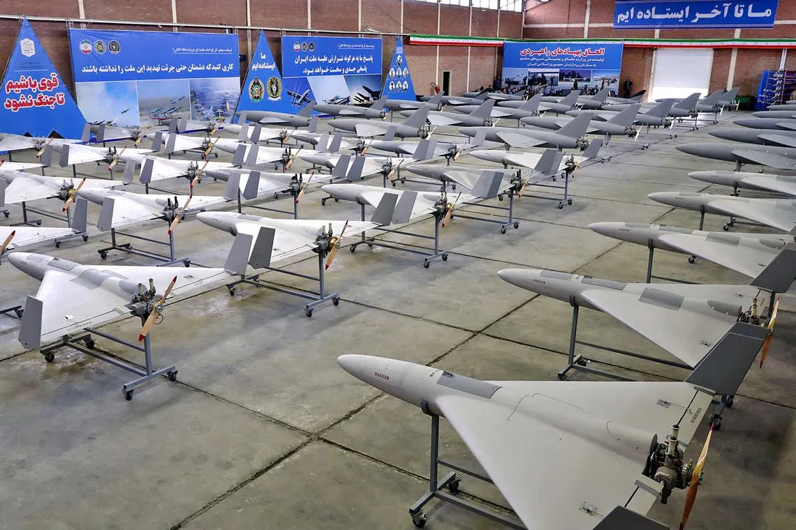 This handout picture released by Iran's Army office on April 19, 2023 shows military unmanned aerial vehicles (UAV or drone) on display during a ceremony at an undisclosed location in Iran. (Photo by Iranian Army office / AFP) / === RESTRICTED TO EDITORIAL USE - MANDATORY CREDIT "AFP PHOTO / HO / IRANIAN ARMY OFFICE" - NO MARKETING NO ADVERTISING CAMPAIGNS - DISTRIBUTED AS A SERVICE TO CLIENTS ===