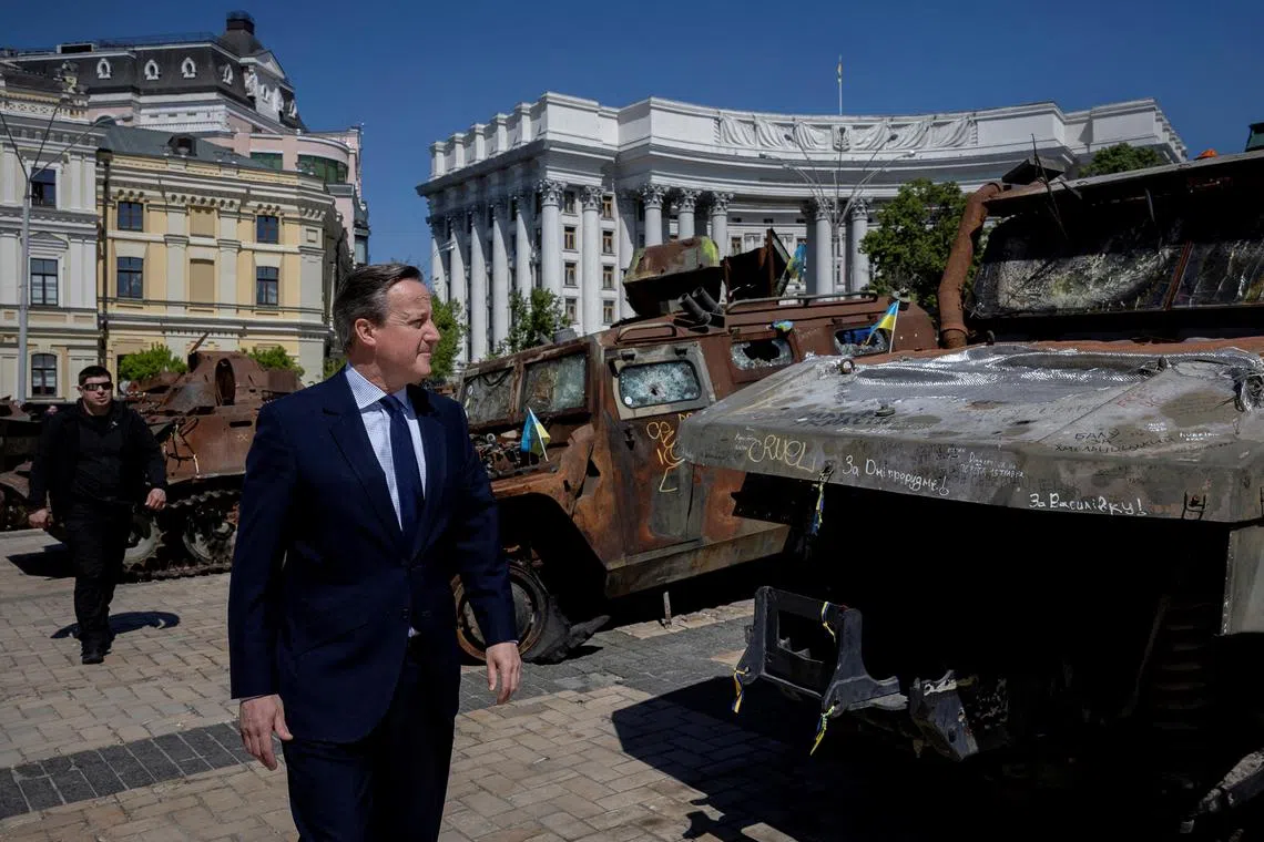 Britain's Foreign Secretary David Cameron walking past a display of destroyed Russian military vehicles in Kyiv, on May 2, 2024.