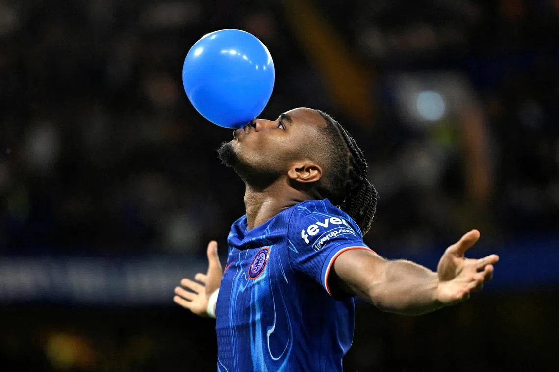 Chelsea's Christopher Nkunku celebrates scoring their first goal against Servette in the Europa Conference League play-offs with a balloon.