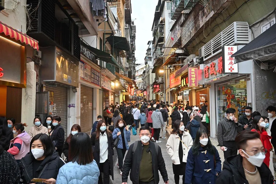 Tourists from mainland China strolling down a street in the southern Chinese enclave of Macau, on Jan 17, 2023.
