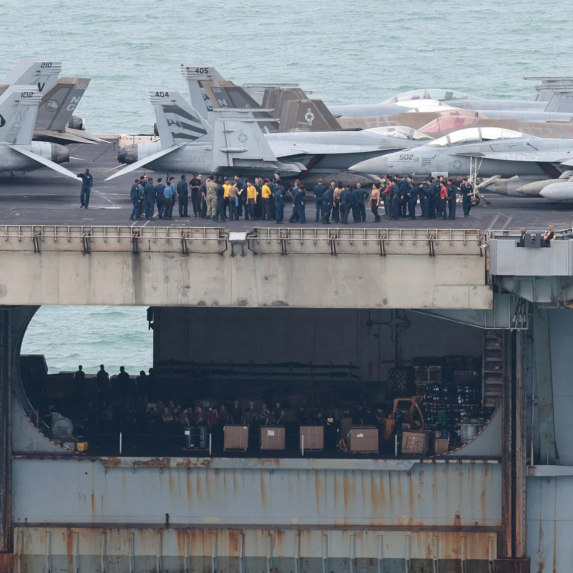 FILE PHOTO: Personnel and aircraft on the deck of the U.S. Navy Nimitz-class aircraft carrier USS Abraham Lincoln as it sails toward Laem Chabang Port before docking for a rest stop following a long deployment in the Middle East, in Chonburi province, Thailand, September 2, 2026. REUTERS/Chalinee Thirasupa/File Photo