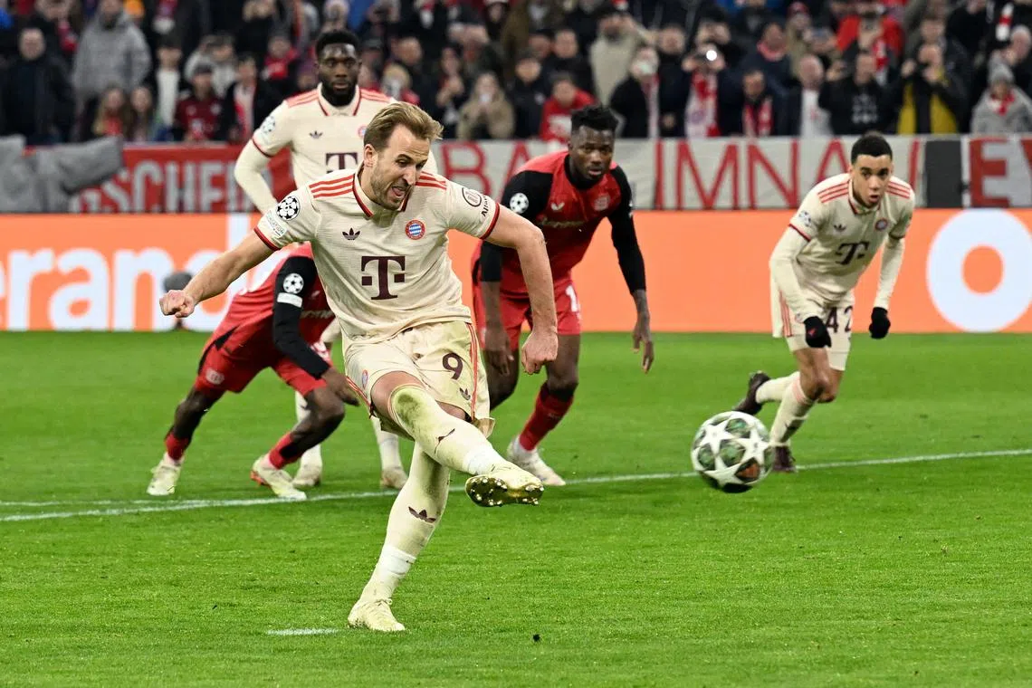 Soccer Football - Champions League - Round of 16 - First Leg - Bayern Munich v Bayer Leverkusen - Allianz Arena, Munich, Germany - March 5, 2025  Bayern Munich's Harry Kane scores their third goal from the penalty spot REUTERS/Angelika Warmuth