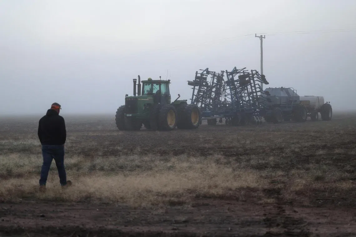 Justin Everitt walks towards his seeding rig on a foggy morning at his farm near Brocklesby, Australia.