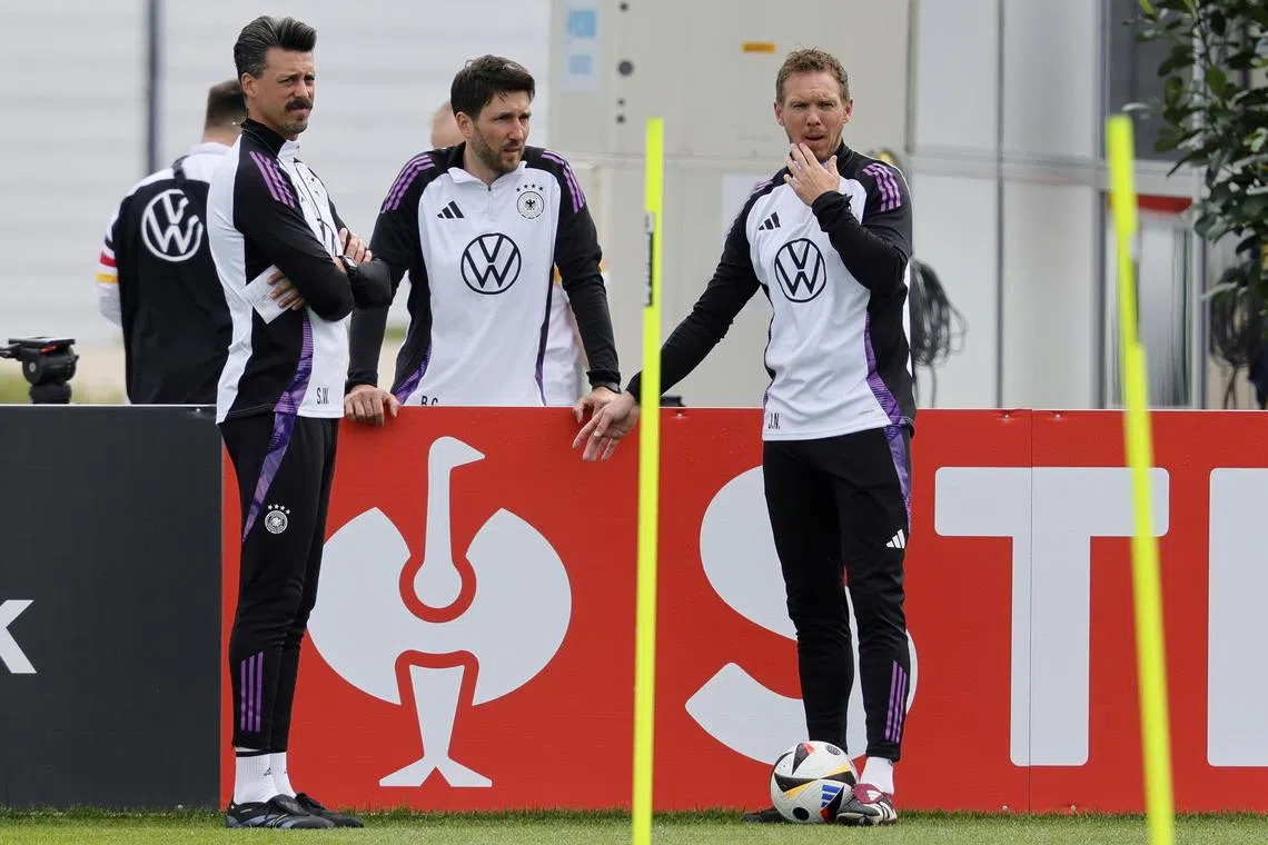 Germany head coach Julian Nagelsmann (right) and assistant coaches Sandro Wagner (left) and Benjamin Glueck (centre) during a training session.