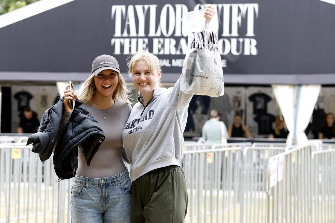 Fans show off their The Eras Tour merchandise they purchased ahead of Taylor Swift's concerts in Melbourne. 