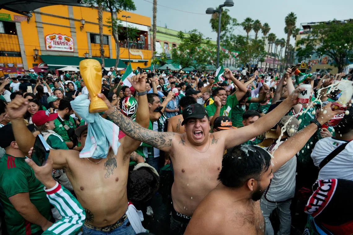 Fans celebrating Mexico’s victory over South Africa during a public viewing of the World Cup opening game at Plaza Garibaldi in Mexico City on June 11.
