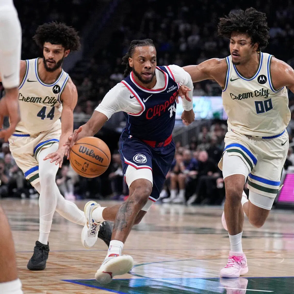 LA Clippers guard Darius Garland drives against Milwaukee Bucks centre Jericho Sims in the first half at Fiserv Forum.